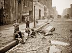Dead horse, cobbled street, children playing in New York