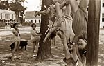 Girls hanging from poles outdoor playground 1938