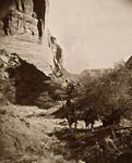 Several Navajo American Indian men at foot of canyon