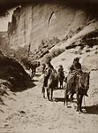 Band of mounted Navahos passing through Canon