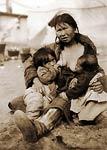 Inuit Eskimo woman breast-feeding two babies