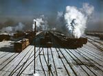 Steam billowing from trains, railroad yard in winter, 1942