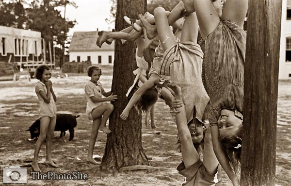 Girls hanging from poles outdoor playground 1938 - Click Image to Close