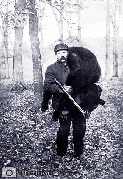 Hunter Carrying a Large Bear. - Click Image to Close