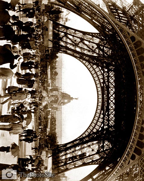 Crowd of people walking under the base of Eiffel Tower 1889 - Click Image to Close