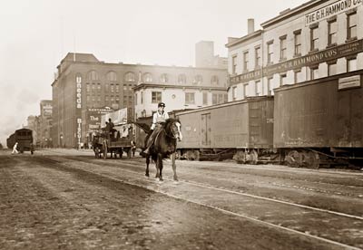 Boy on horse, railroad cars 11th Ave New York City