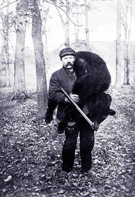 Hunter Carrying a Large Bear.