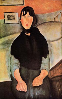 dark young woman seated by a bed 1918