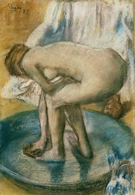 Woman bathing in a shallow tub