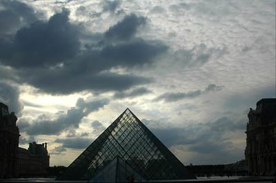 Louvre pyramid and dramatic sky, Paris