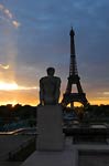 Nude statue and sunrise at Eiffel Tower